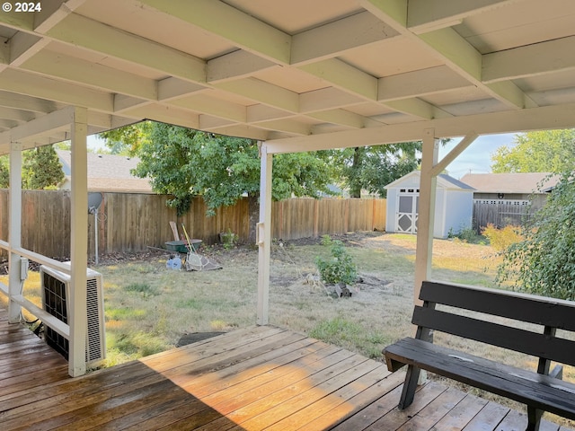 wooden terrace with a storage shed