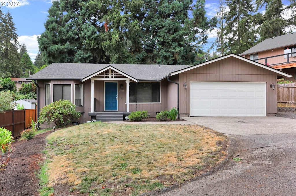 view of front of property with a garage and a front lawn