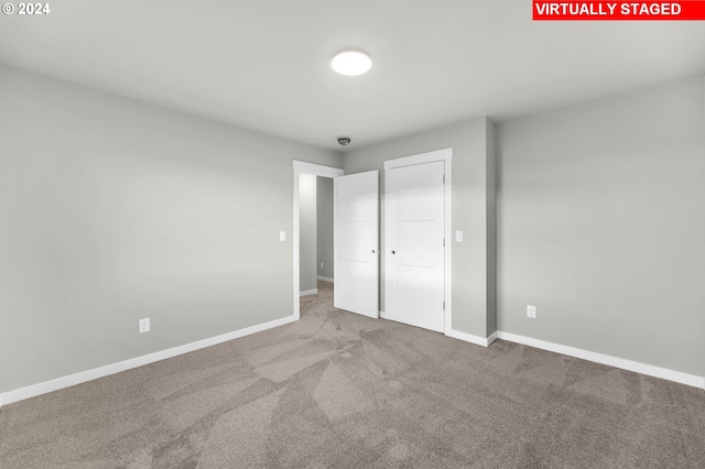 unfurnished bedroom with carpet floors