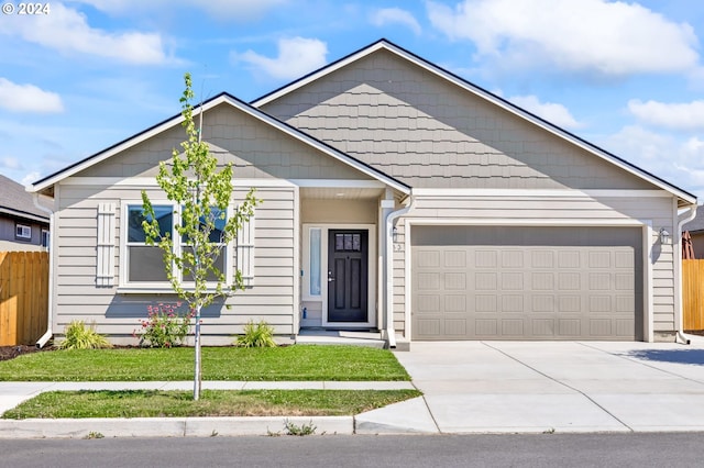 view of front of home featuring a garage and a front lawn