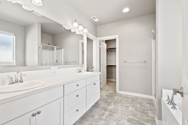 bathroom with vanity and a shower with door