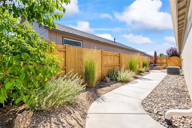 view of yard featuring central AC unit and a patio