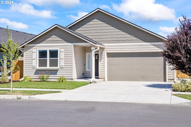 view of front of house with a garage and a front yard