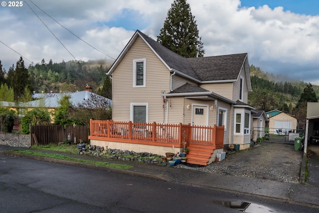 front facade with an outdoor structure and a garage