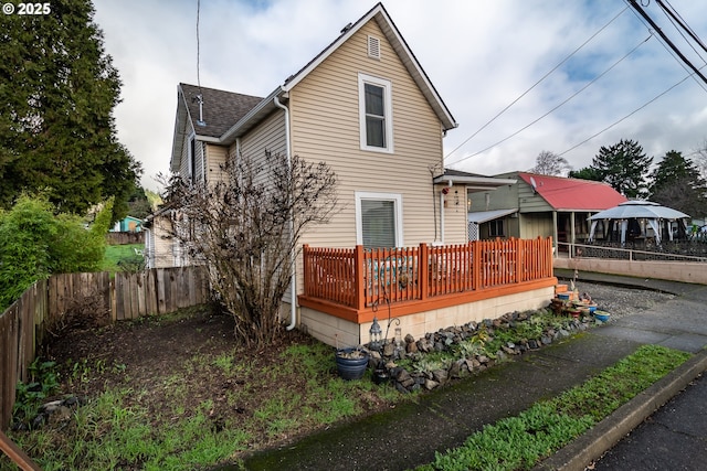 back of house with a wooden deck