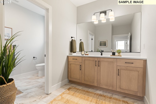 bathroom with marble finish floor, visible vents, toilet, vanity, and baseboards