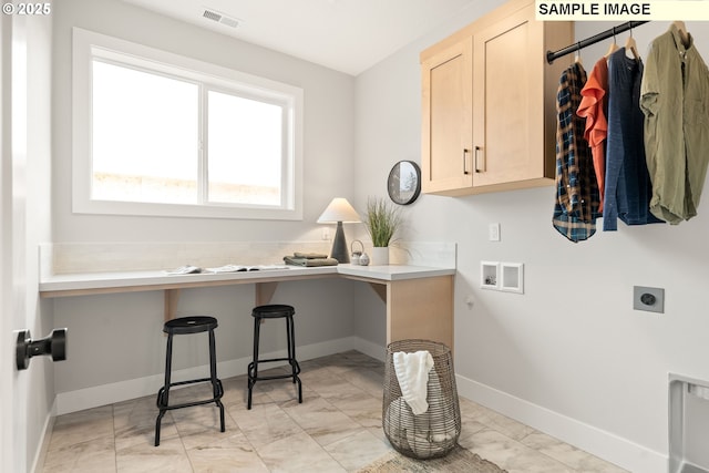 laundry room with hookup for an electric dryer, washer hookup, visible vents, baseboards, and cabinet space