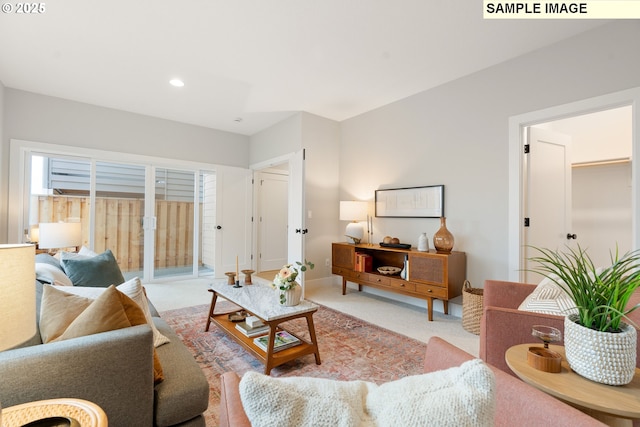 living room with recessed lighting, light colored carpet, and baseboards