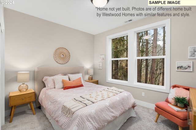 carpeted bedroom featuring baseboards and visible vents