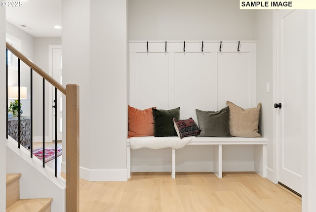 mudroom with wood finished floors and baseboards