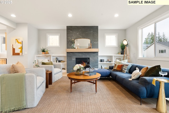 living room with recessed lighting, a healthy amount of sunlight, and a fireplace