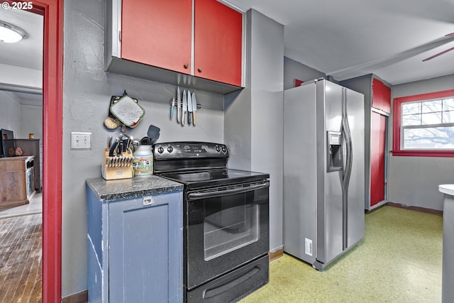 kitchen with light floors, dark countertops, stainless steel fridge with ice dispenser, black range with electric cooktop, and baseboards