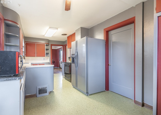 kitchen featuring open shelves, light floors, dark countertops, and stainless steel fridge with ice dispenser