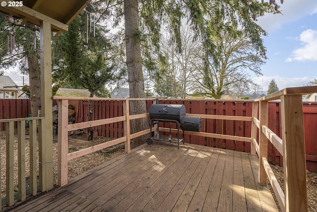 wooden terrace featuring a grill