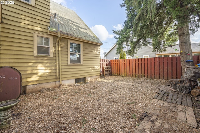 view of yard featuring heating fuel and fence