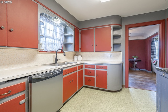 kitchen with dishwasher, open shelves, a sink, and red cabinets