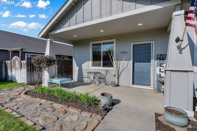 view of exterior entry featuring a patio area