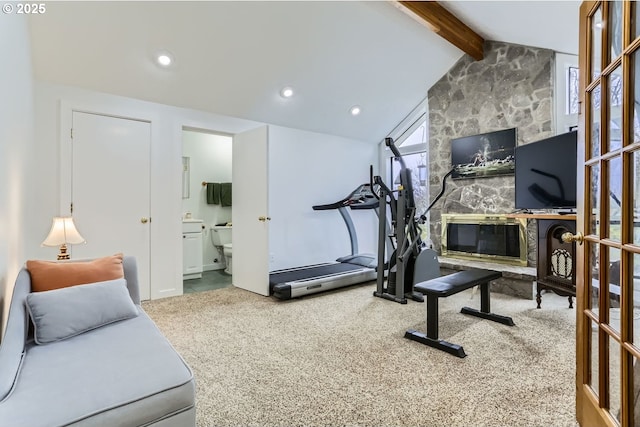 exercise area with vaulted ceiling and carpet flooring