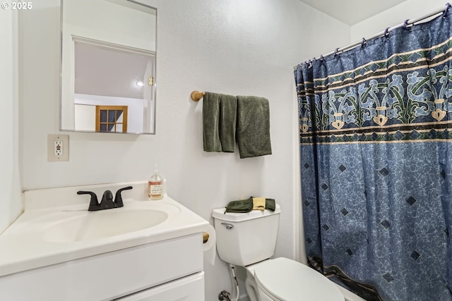 bathroom with toilet and vanity