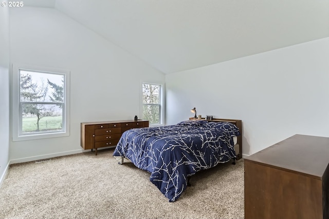 carpeted bedroom with vaulted ceiling