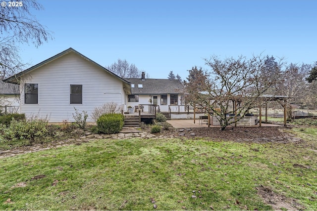 back of property with a patio, a yard, and a wooden deck