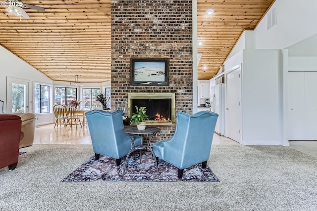 living room featuring ceiling fan, wood ceiling, high vaulted ceiling, and a fireplace