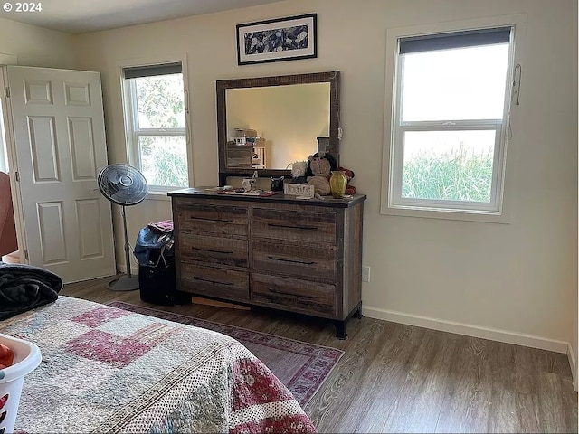 bedroom with dark wood-type flooring