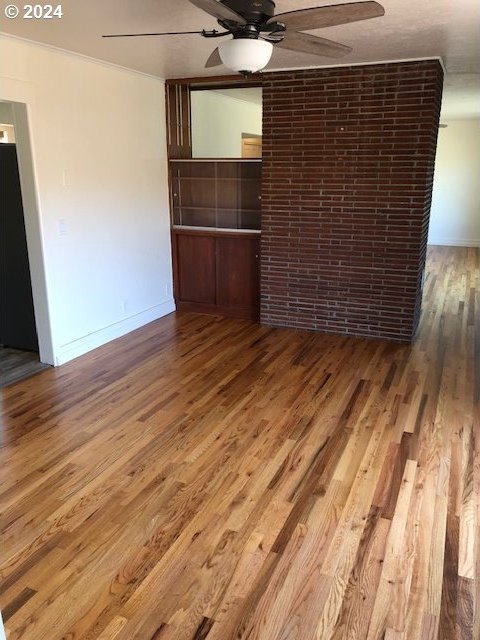 spare room with ceiling fan and hardwood / wood-style floors