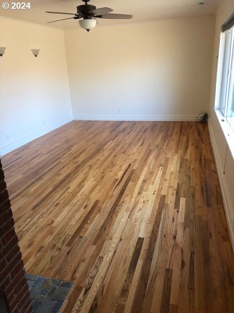 spare room with ceiling fan and hardwood / wood-style flooring