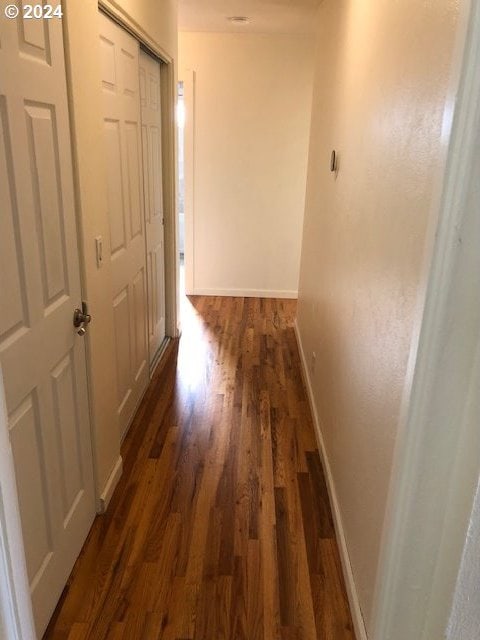 corridor featuring dark hardwood / wood-style flooring