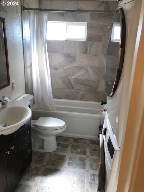 full bathroom with shower / bath combo, toilet, and vanity