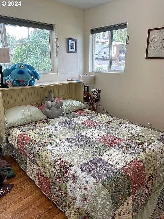 bedroom with hardwood / wood-style floors