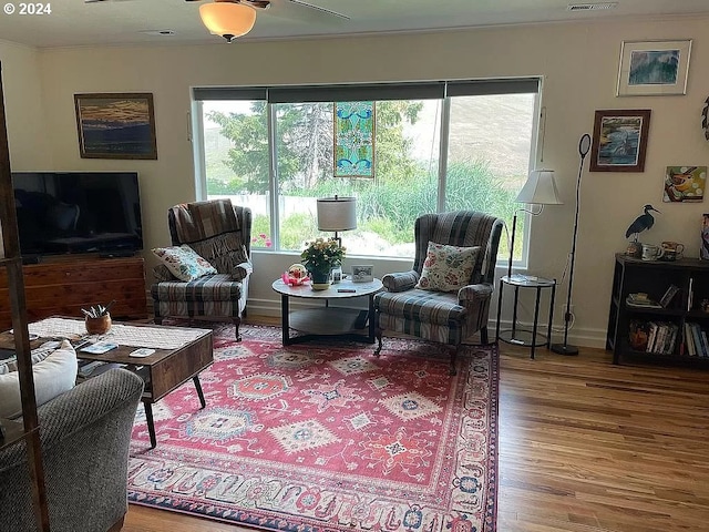 living room featuring hardwood / wood-style flooring and ceiling fan