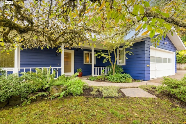 view of front of home with a porch and a garage