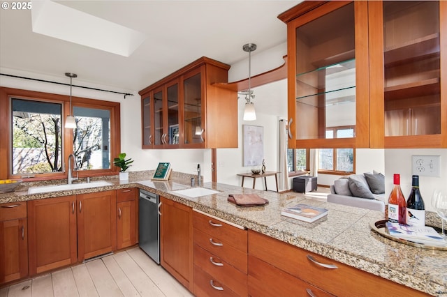 kitchen with sink, light hardwood / wood-style floors, hanging light fixtures, and dishwasher