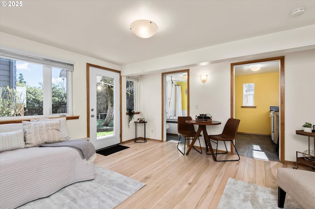 bedroom with connected bathroom and light hardwood / wood-style floors