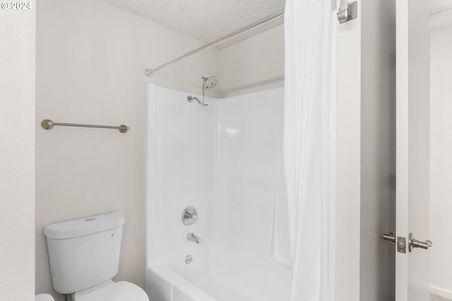 bathroom featuring toilet, a textured ceiling, and shower / tub combo with curtain