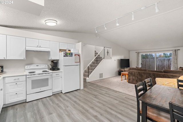 kitchen with white cabinets, light wood-type flooring, white appliances, and lofted ceiling