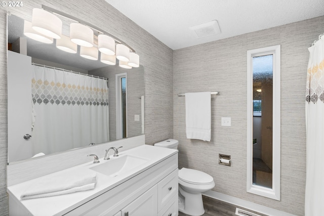 bathroom featuring hardwood / wood-style floors, vanity, and toilet