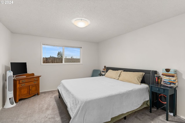 carpeted bedroom featuring a textured ceiling