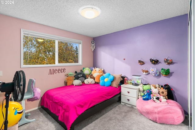 bedroom with a textured ceiling and light carpet