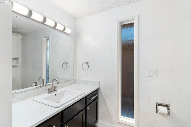 bathroom featuring vanity and a textured ceiling