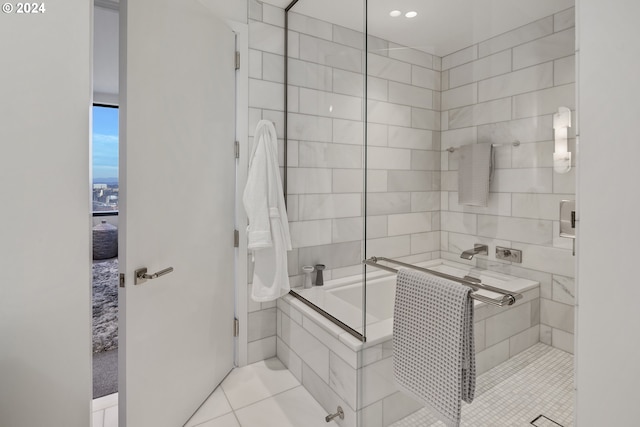 full bathroom featuring a tub, tile patterned flooring, and tiled shower