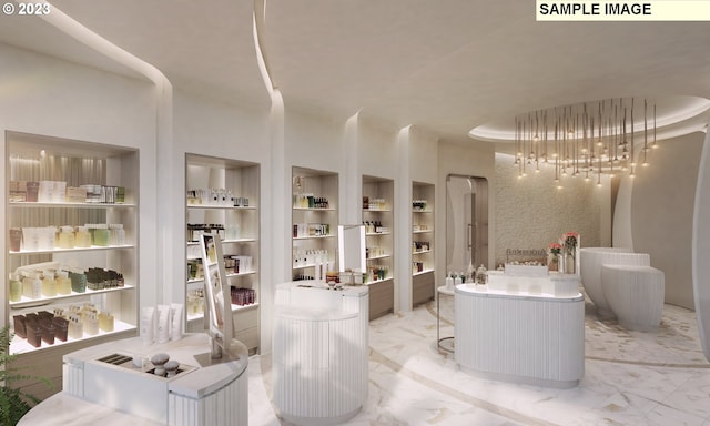 bathroom with built in shelves, a tray ceiling, and marble finish floor