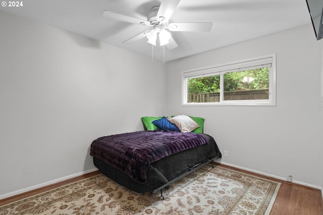 bedroom featuring ceiling fan and hardwood / wood-style flooring