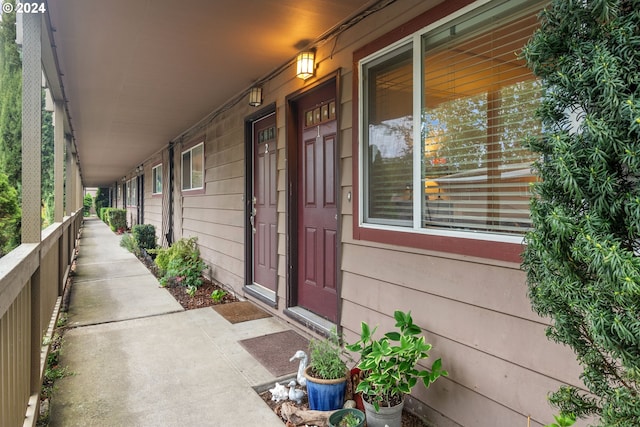 view of exterior entry featuring covered porch