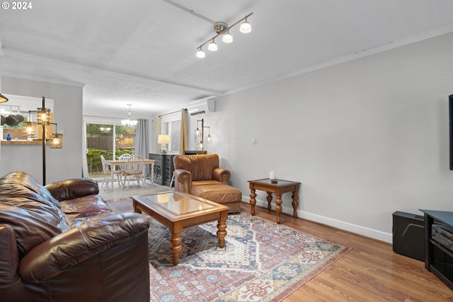 living room featuring crown molding, a wall mounted AC, hardwood / wood-style floors, a notable chandelier, and track lighting