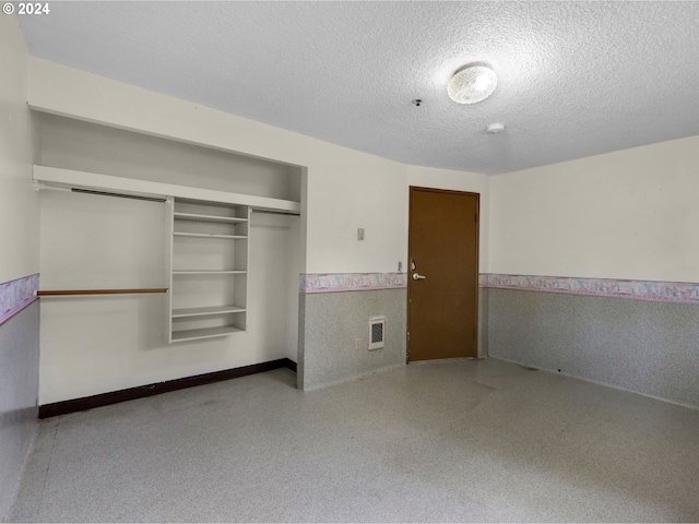 unfurnished bedroom featuring a closet and a textured ceiling