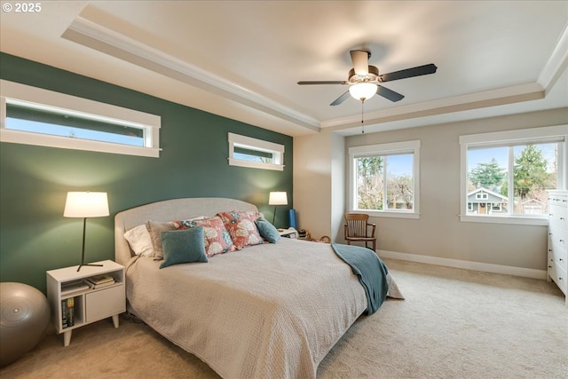 bedroom with baseboards, a raised ceiling, carpet floors, and crown molding