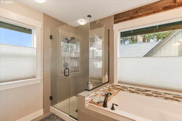 bathroom featuring a bath and a shower stall